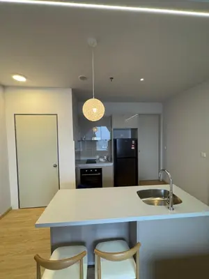 a kitchen with a sink and two chairs at trion kl TRX klcc view in Kuala Lumpur