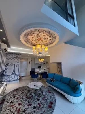 a living room with a blue couch and a table at Duplex Arte Mont Kiara modern design nice view in Kuala Lumpur