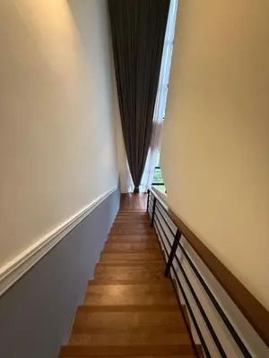 a hallway with a window and a wooden floor at Duplex Arte Mont Kiara modern design nice view in Kuala Lumpur