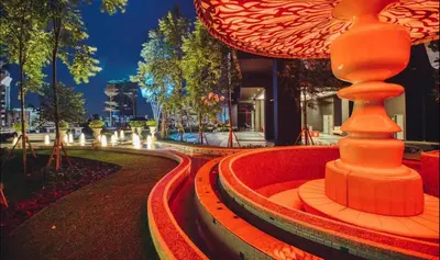 a fountain in the middle of a city at night at Duplex Arte Mont Kiara modern design nice view in Kuala Lumpur