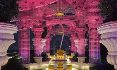 a building with pink and purple walls and columns at Duplex Arte Mont Kiara modern design nice view in Kuala Lumpur