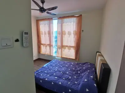 a bedroom with a bed and a ceiling fan at Zetapak homestay in Kuala Lumpur