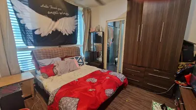 a bedroom with a large bed with a bird on the wall at Zetapak homestay in Kuala Lumpur
