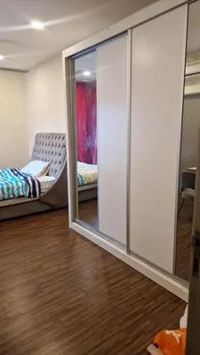 a room with a sliding glass door and a bed at Zetapak homestay in Kuala Lumpur