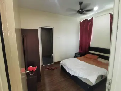 a bedroom with a bed and a ceiling fan at Zetapak homestay in Kuala Lumpur