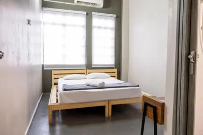 a bed in a room with a window at Pak Fook Hotel Chow Kit in Kuala Lumpur