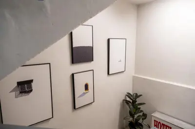 a hallway with four pictures on a wall at Pak Fook Hotel Chow Kit in Kuala Lumpur
