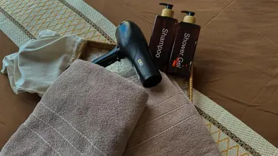 a hair dryer sitting on top of a towel at Just Stay Axon Residence Suite Bukit Bintang in Kuala Lumpur