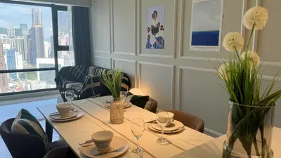 a dining room with a table and chairs and a window at Just Stay Axon Residence Suite Bukit Bintang in Kuala Lumpur