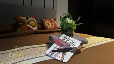 a book and a plant sitting on a table at Just Stay Axon Residence Suite Bukit Bintang in Kuala Lumpur