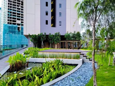a garden with rocks and plants in front of a building at Just Stay Axon Residence Suite Bukit Bintang in Kuala Lumpur