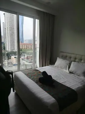 a bedroom with a bed and a large window at 1Bukit ceylon view 118 in Kuala Lumpur