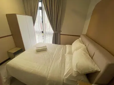 a white bed in a room with a window at KL City, Neu Suites 2Bedroom 1Bathroom in Kuala Lumpur