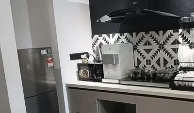 a kitchen counter with a microwave and a refrigerator at 6pax 2BR KL118 View 5min to train Station in Kuala Lumpur