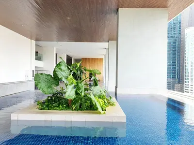 a pool with a plant in the middle of a building at The Establisment KL Sentral by GBS in Kuala Lumpur