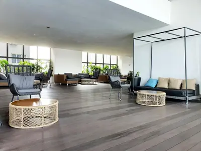 a lobby with chairs and a couch and tables at The Establisment KL Sentral by GBS in Kuala Lumpur
