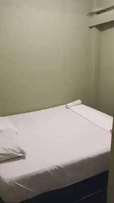 a large white bed in a room with at Health Homestay KL in Kuala Lumpur