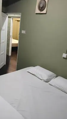 a white bed with two pillows in a bedroom at Health Homestay KL in Kuala Lumpur