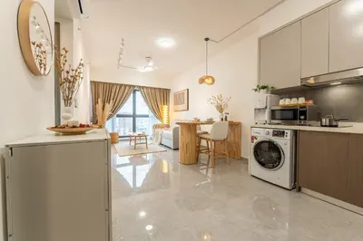 a kitchen and living room with a washer and dryer at TRX View Muji Room 5 min to Bukit Bintang at Agile in Kuala Lumpur