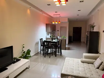 a living room with a couch and a table at Cosy Studio Apartment at Hartamas in Kuala Lumpur