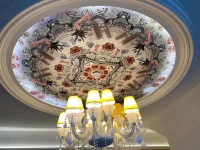 a chandelier with a painting on a ceiling at Duplex Arte Mont kiara 2 bedroom in Kuala Lumpur