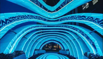 a tunnel at the end of a building with blue lights at Duplex Arte Mont kiara 2 bedroom in Kuala Lumpur