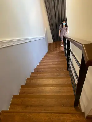 a woman walking down the stairs in a building at Duplex Arte Mont kiara 2 bedroom in Kuala Lumpur