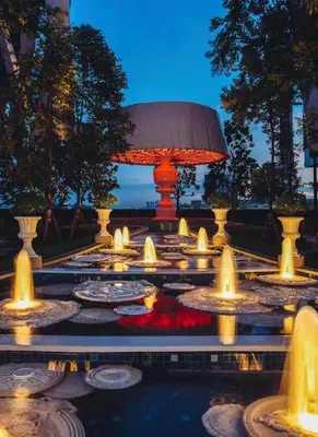 a lit up fountain with a lamp in the middle at Arte mont kiara duplex 2 bedroom in Kuala Lumpur