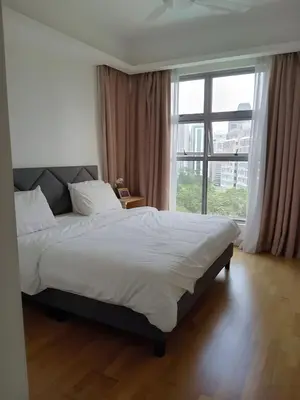a bedroom with a large bed and a large window at Suasana Bukit Ceylon by Goldcrests Global in Kuala Lumpur
