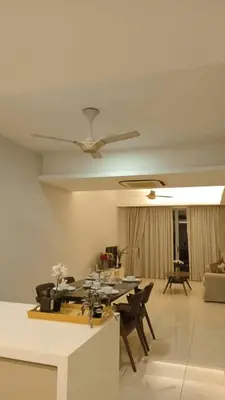 a living room with a ceiling fan and a table at Suasana Bukit Ceylon by Goldcrests Global in Kuala Lumpur