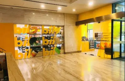 a room with a store with yellow walls and a wooden floor at Suasana Bukit Ceylon by Goldcrests Global in Kuala Lumpur