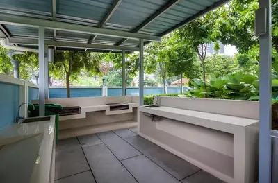a patio with benches and a view of a pool at Suasana Bukit Ceylon by Goldcrests Global in Kuala Lumpur