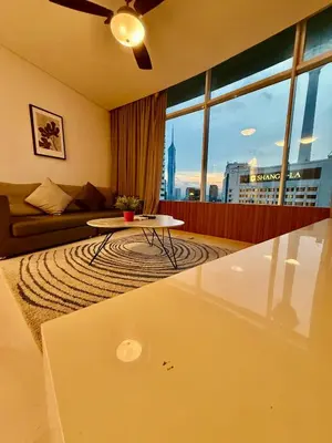 a living room with a couch and a table at Vortex Suites By Asian in Kuala Lumpur