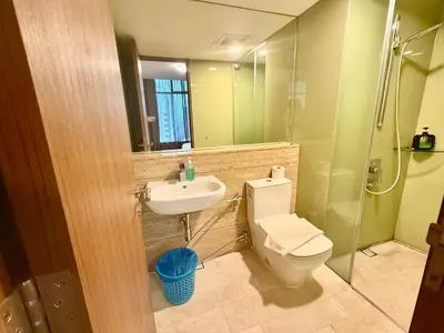 a bathroom with a toilet and a sink and a shower at Vortex Suites By Asian in Kuala Lumpur