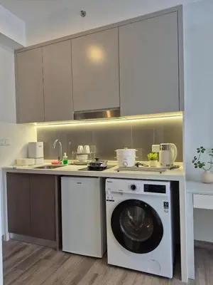 a kitchen with a washer and a washing machine at Comfort Luxury Studio Kuala Lumpur Free Netflix #S3 in Kuala Lumpur