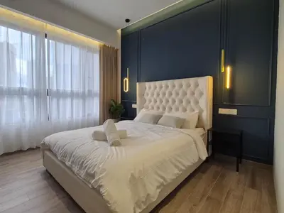 a bedroom with a large white bed with a blue wall at Comfort Luxury Studio Kuala Lumpur Free Netflix #S3 in Kuala Lumpur