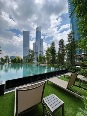a large pool of water with two chairs and a bench at Comfort Luxury Studio Kuala Lumpur Free Netflix #S3 in Kuala Lumpur