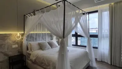 a bedroom with a canopy bed with a large window at Design House Kuala Lumpur #P3 in Kuala Lumpur