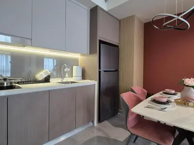 a kitchen with a table and a refrigerator at Design House Kuala Lumpur #P3 in Kuala Lumpur