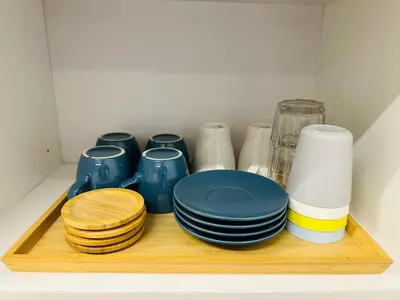 a shelf with blue plates and other dishes on it at The Establishment LOFT Bangsar KL Sentral by \u54c1\u5c4b PINWU Shortstay in Kuala Lumpur
