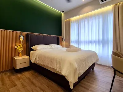 a bedroom with a large bed with a green wall at Agile Kuala Lumpur 4min TRX Pavillion #P8 in Kuala Lumpur