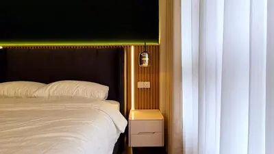 a bedroom with a white bed with a black headboard at Agile Kuala Lumpur 4min TRX Pavillion #P8 in Kuala Lumpur