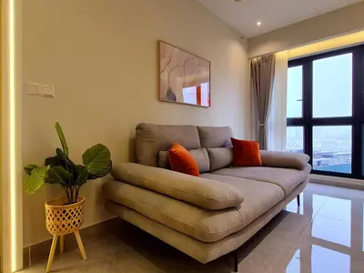 a living room with a couch and a plant at Agile Kuala Lumpur 4min TRX Pavillion #P8 in Kuala Lumpur