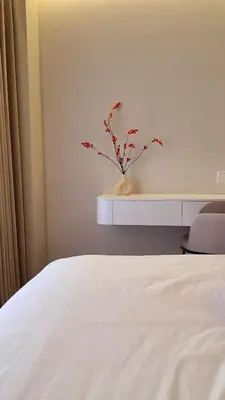 a white bed with a vase with a plant in it at Agile Kuala Lumpur 4min TRX Pavillion #P8 in Kuala Lumpur
