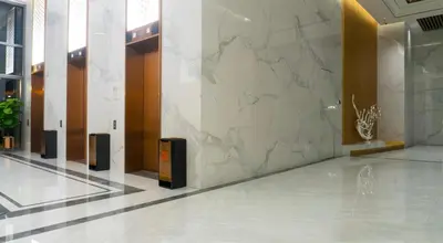 a lobby with a marble wall in a building at Core Residence at TRX by LL in Kuala Lumpur