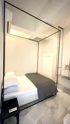 a glass room with a bed and a table at 2 Bedroom Apartment l City View in Kuala Lumpur