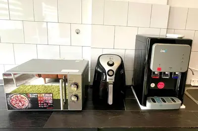 a counter top with a video game system next to a box at 2 Bedroom Apartment l City View in Kuala Lumpur