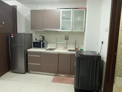 a small kitchen with a sink and a refrigerator at Serene Haven in Kuala Lumpur