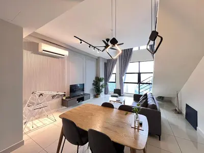 a dining room and living room with a table and chairs at Arte Mont Kiara By Comfortstay in Kuala Lumpur