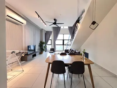 a living room with a table and chairs at Arte Mont Kiara By Comfortstay in Kuala Lumpur